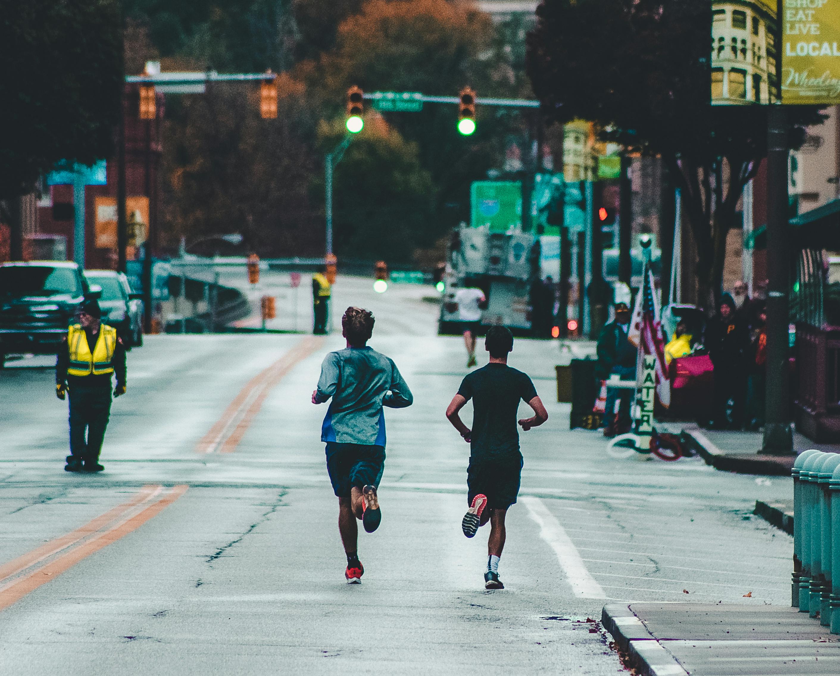 Two runners on a city street.
