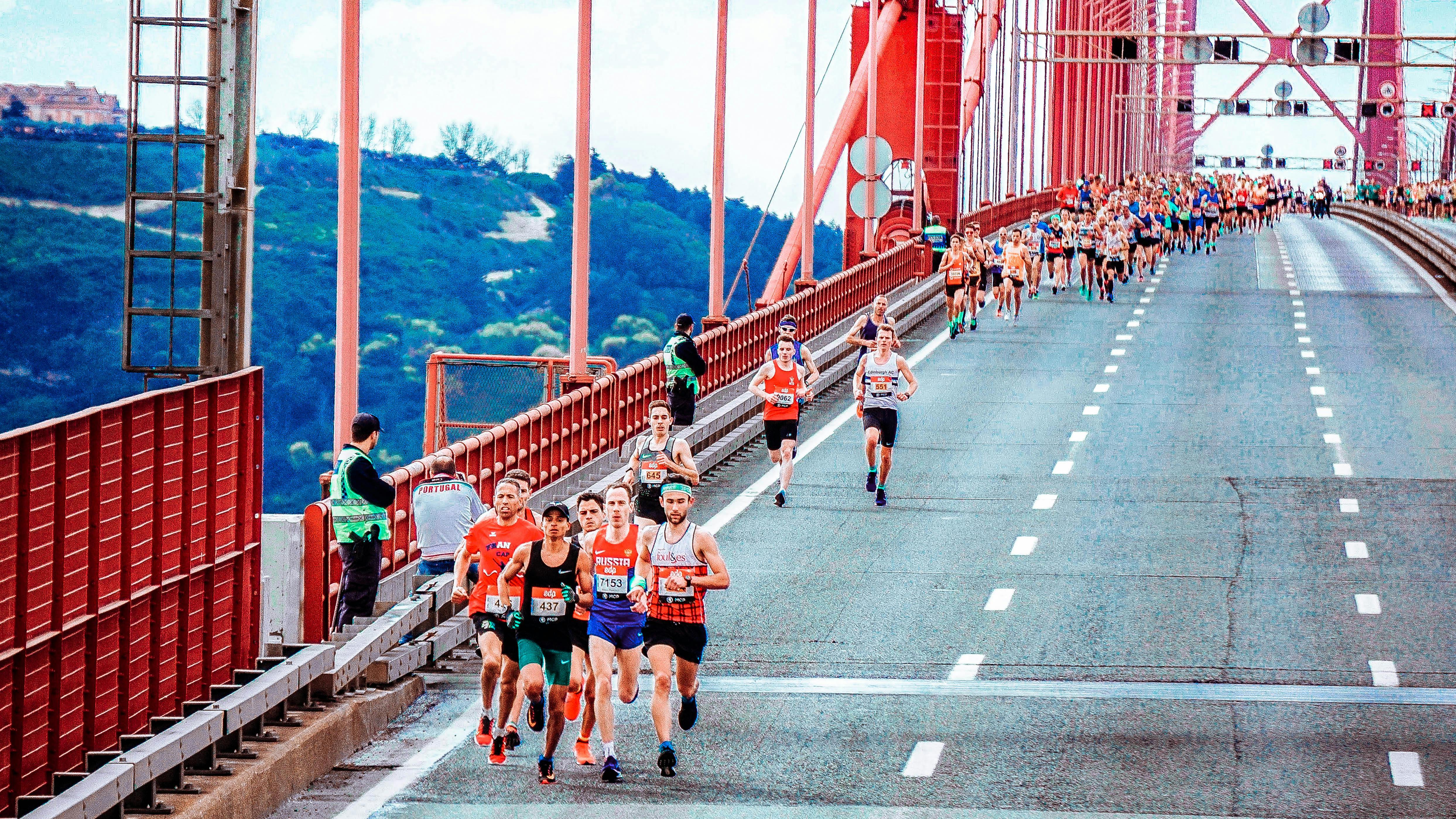 Group of runners crossing a bridge.